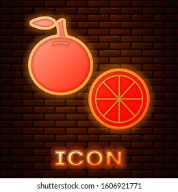 Glowing neon Orange fruit icon isolated on brick wall background.  Vector Illustration