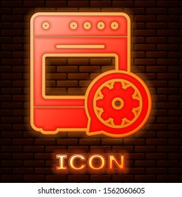 Glowing neon Oven and gear icon isolated on brick wall background. Adjusting app, service concept, setting options, maintenance, repair, fixing.  Vector Illustration