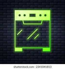 Glowing neon Oven icon isolated on brick wall background. Stove gas oven sign.  Vector