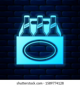 Glowing neon Pack of beer bottles icon isolated on brick wall background. Case crate beer box sign.  Vector Illustration