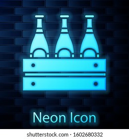 Glowing neon Pack of beer bottles icon isolated on brick wall background. Wooden box and beer bottles. Case crate beer box sign.  Vector Illustration