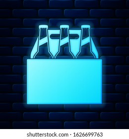 Glowing neon Pack of beer bottles icon isolated on brick wall background. Case crate beer box sign.  Vector Illustration