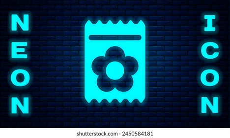 Glowing neon Pack full of seeds of a specific plant icon isolated on brick wall background.  Vector Illustration