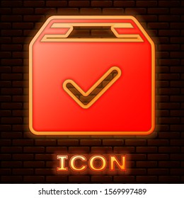 Glowing neon Package box with check mark icon isolated on brick wall background. Parcel box with checkmark. Approved delivery or successful package receipt.  Vector Illustration