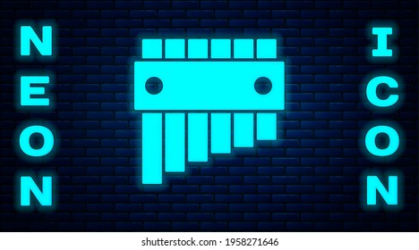 Glowing neon Pan flute icon isolated on brick wall background. Traditional peruvian musical instrument. Folk instrument from Peru, Bolivia and Mexico.  Vector