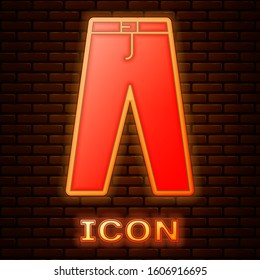 Glowing neon Pants icon isolated on brick wall background.  Vector Illustration