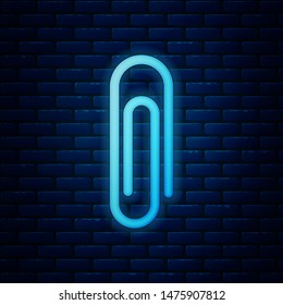 Glowing neon Paper clip icon isolated on brick wall background.  Vector Illustration