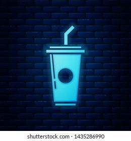Glowing neon Paper glass with drinking straw and water icon isolated on brick wall background. Soda drink glass. Fresh cold beverage symbol.  Vector Illustration
