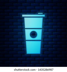 Glowing neon Paper glass and water icon isolated on brick wall background. Soda drink glass. Fresh cold beverage symbol.  Vector Illustration