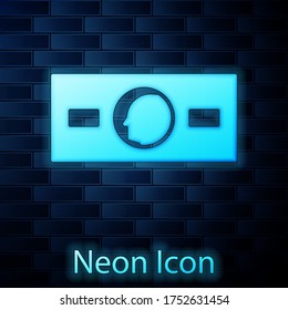 Glowing neon Paper money cash icon isolated on brick wall background. Money banknotes stacks. Bill currency. Vector Illustration