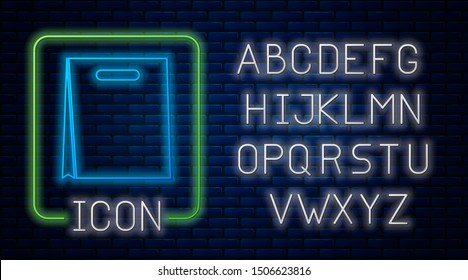 Glowing neon Paper shopping bag icon isolated on brick wall background. Package sign. Neon light alphabet. Vector Illustration