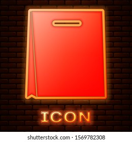 Glowing neon Paper shopping bag icon isolated on brick wall background. Package sign.  Vector Illustration