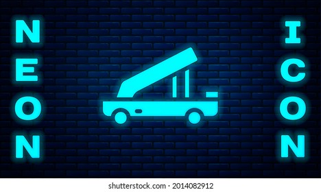 Glowing neon Passenger ladder for plane boarding icon isolated on brick wall background. Airport stair travel.  Vector