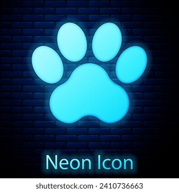 Glowing neon Paw print icon isolated on brick wall background. Dog or cat paw print. Animal track.  Vector