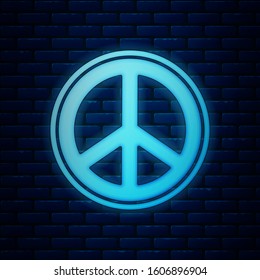 Glowing neon Peace icon isolated on brick wall background. Hippie symbol of peace.  Vector Illustration