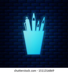 Glowing neon Pencil case stationery icon isolated on brick wall background. Pencil, pen, ruler in a glass for office.  Vector Illustration