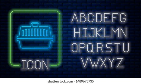 Glowing neon Pet carry case icon isolated on brick wall background. Carrier for animals, dog and cat. Container for animals. Animal transport box. Neon light alphabet. Vector Illustration