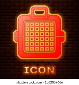 Glowing neon Pet carry case icon isolated on brick wall background. Carrier for animals, dog and cat. Container for animals. Animal transport box.  Vector Illustration
