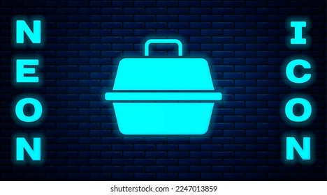 Glowing neon Pet carry case icon isolated on brick wall background. Carrier for animals, dog and cat. Container for animals. Animal transport box.  Vector