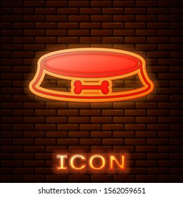 Glowing neon Pet food bowl for cat or dog icon isolated on brick wall background. Dog bone sign.  Vector Illustration