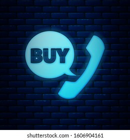 Glowing neon Phone and speech bubble with text Buy icon isolated on brick wall background. Online buying symbol. Supermarket basket symbol.  Vector Illustration