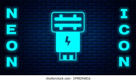 Glowing neon Photo camera flash icon isolated on brick wall background.  Vector
