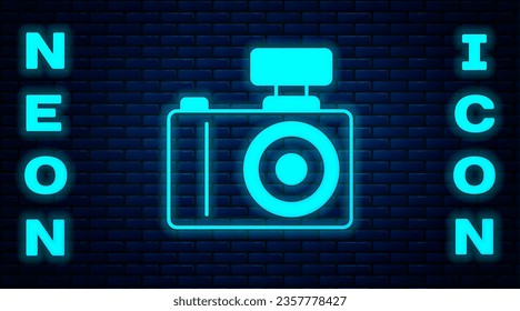 Glowing neon Photo camera icon isolated on brick wall background. Foto camera. Digital photography.  Vector