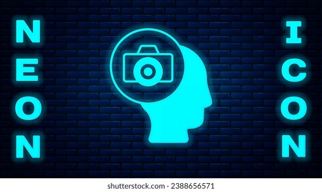 Glowing neon Photo camera icon isolated on brick wall background. Foto camera. Digital photography.  Vector