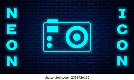 Glowing neon Photo camera icon isolated on brick wall background. Foto camera. Digital photography.  Vector