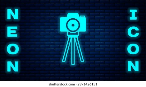 Glowing neon Photo camera icon isolated on brick wall background. Foto camera. Digital photography.  Vector