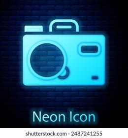 Glowing neon Photo camera icon isolated on brick wall background. Foto camera. Digital photography.  Vector