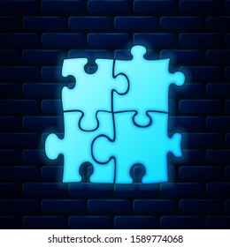 Glowing neon Piece of puzzle icon isolated on brick wall background. Business, marketing, finance, template, layout, infographics, internet concept.  Vector Illustration