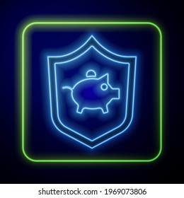 Glowing neon Piggy bank with shield icon isolated on blue background. Icon saving or accumulation of money, investment.  Vector