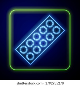 Glowing neon Pills in blister pack icon isolated on blue background. Medical drug package for tablet, vitamin, antibiotic, aspirin.  Vector Illustration