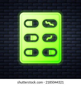 Glowing neon Pills in blister pack icon isolated on brick wall background. Medical drug package for tablet, vitamin, antibiotic, aspirin.  Vector
