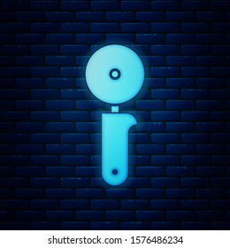 Glowing neon Pizza knife icon isolated on brick wall background. Pizza cutter sign. Steel kitchenware equipment.  Vector Illustration