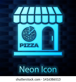 Glowing neon Pizzeria building facade icon isolated on brick wall background. Fast food pizzeria kiosk. Vector Illustration