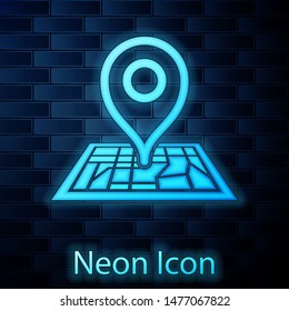 Glowing neon Placeholder on map paper in perspective icon isolated on brick wall background.  Vector Illustration