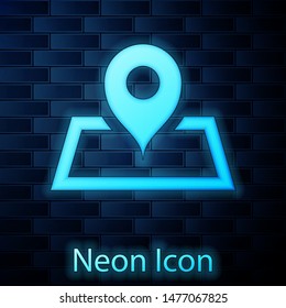 Glowing neon Placeholder on map paper in perspective icon isolated on brick wall background.  Vector Illustration