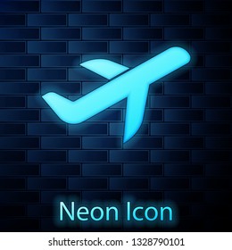 Glowing neon Plane icon isolated on brick wall background. Flying airplane icon. Airliner sign. Vector Illustration