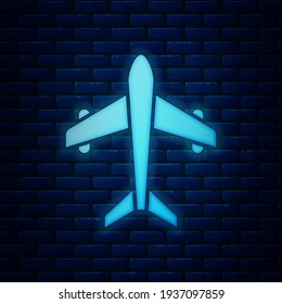 Glowing neon Plane icon isolated on brick wall background. Flying airplane. Airliner insurance. Security, safety, protection, protect concept.  Vector