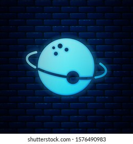 Glowing neon Planet icon isolated on brick wall background.  Vector Illustration