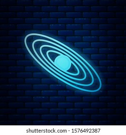 Glowing neon Planet icon isolated on brick wall background.  Vector Illustration