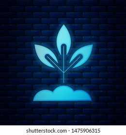 Glowing neon Plant icon isolated on brick wall background. Seed and seedling. Leaves sign. Leaf nature.  Vector Illustration