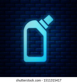 Glowing neon Plastic bottle for liquid laundry detergent, bleach, dishwashing liquid or another cleaning agent icon isolated on brick wall background.  Vector Illustration