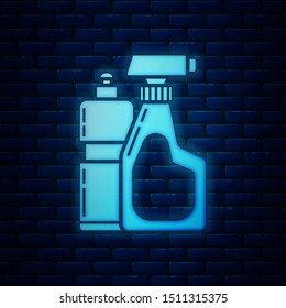 Glowing neon Plastic bottles for liquid laundry detergent, bleach, dishwashing liquid or another cleaning agent icon isolated on brick wall background.  Vector Illustration