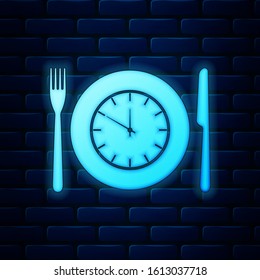 Glowing neon Plate with clock, fork and knife icon isolated on brick wall background. Lunch time. Eating, nutrition regime, meal time and diet concept.  Vector Illustration