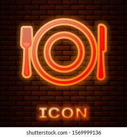 Glowing neon Plate, fork and knife icon isolated on brick wall background. Cutlery symbol. Restaurant sign.  Vector Illustration