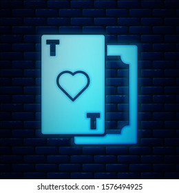 Glowing neon Playing card with heart symbol icon isolated on brick wall background. Casino gambling.  Vector Illustration