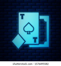 Glowing neon Playing card with spades symbol icon isolated on brick wall background. Casino gambling.  Vector Illustration